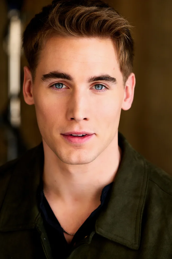 Nick in a green shirt, facing camera with blue eyes and a relaxed expression