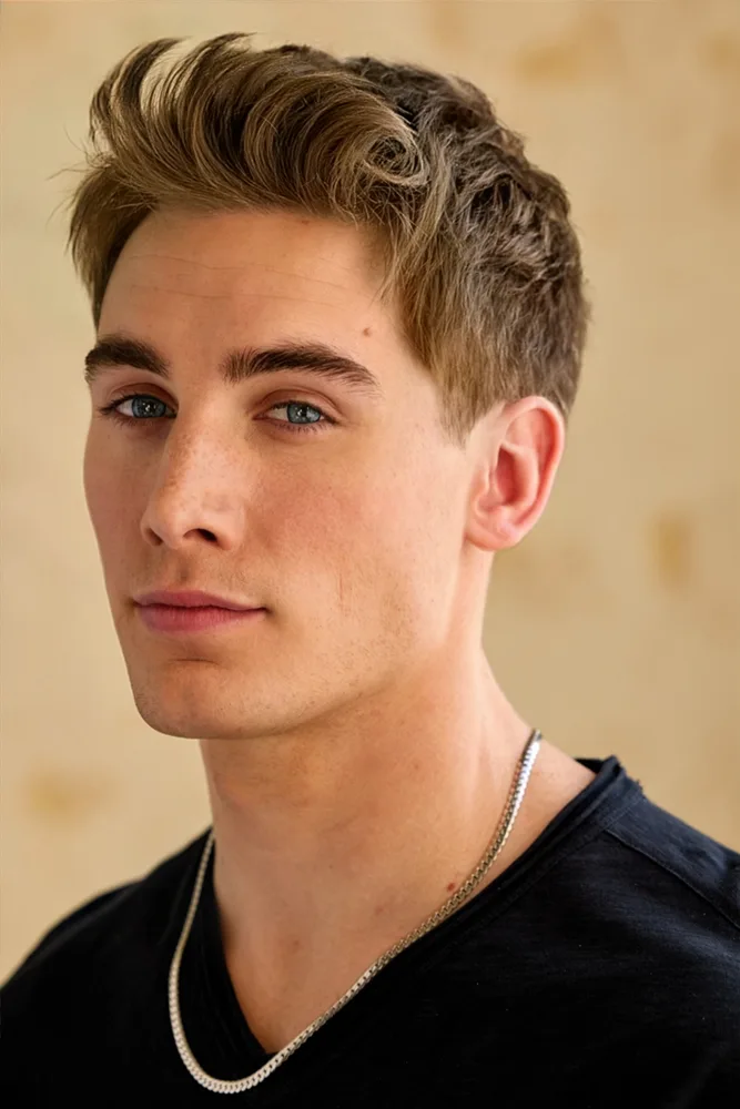 Nick in a black shirt, looking at camera in warm natural light
